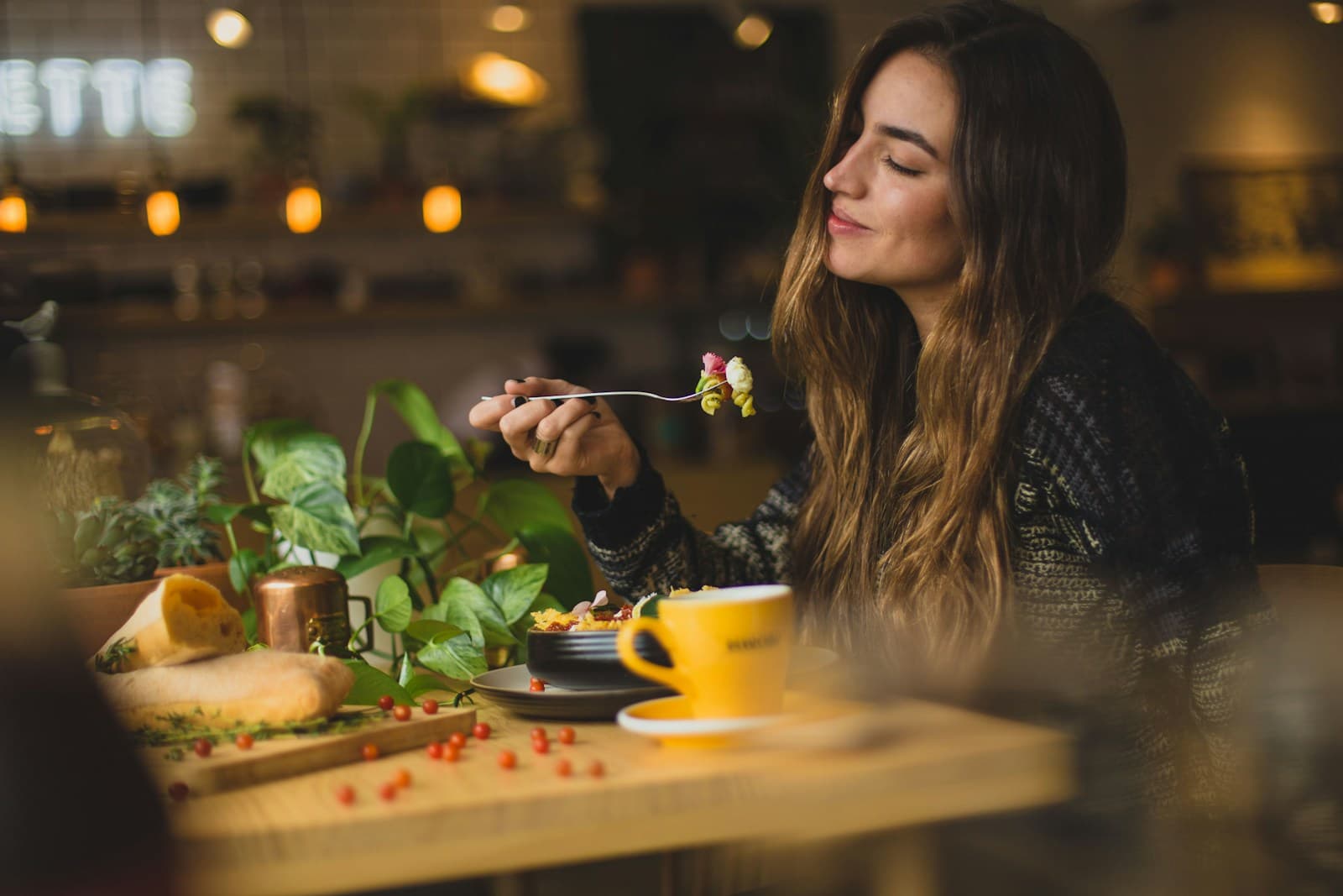 New York's Most Incredible Restaurants: 10 Must-Visit Spots from Casual to Luxury. woman holding fork in front table
